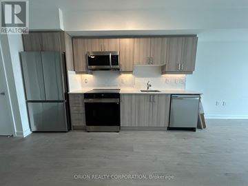 Toronto (Yorkdale-Glen Park) condo for rent - A kitchen with a refrigerator, oven, and microwave.