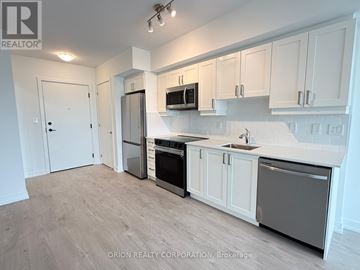 Toronto (Yorkdale-Glen Park) condo for rent - A kitchen with white cabinets and stainless steel appliances.