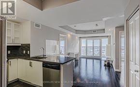 Ottawa condo for rent - A modern kitchen with black countertops and white cabinets.