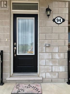 Kitchener townhouse for rent - A black door with a glass window and a sign that says REALTOR.
