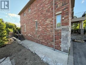 King (King City) apartment for rent - A red brick house with a white window and a black gate.