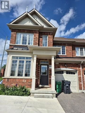 Brampton (Northwest Brampton) apartment for rent - A house with a black door and a garage.