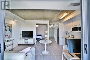 Toronto (Waterfront Communities) condo for rent - A modern living room with a white couch and a television.