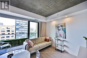 Toronto (Waterfront Communities) condo for rent - A living room with a couch, a table, and a painting on the wall.