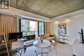 Toronto (Waterfront Communities) condo for rent - A living room with a couch, chairs, and a television.