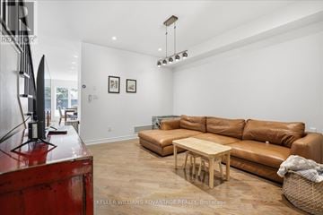 Toronto (The Beaches) apartment for rent - A living room with a brown leather couch and a wooden coffee table.