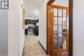 Brantford apartment for rent - A hallway with a wooden door leading to a bedroom.