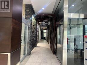 Mississauga (City Centre) condo for rent - A living room with a white couch and a television on a stand.