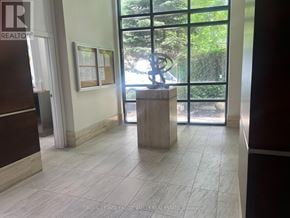Mississauga (City Centre) condo for rent - A living room with a white couch and a rug.