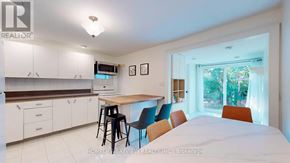 Toronto (Weston-Pellam Park) apartment for rent - A kitchen with white cabinets and a countertop with a microwave and oven.