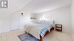 Toronto (Weston-Pellam Park) apartment for rent - A bedroom with a bed, a small table, and a window.