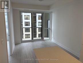 Mississauga (City Centre) condo for rent - A room with a large window and a door leading to a balcony.