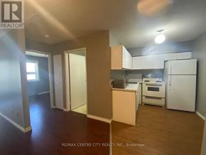 London North (North G) condo for rent - A kitchen area with white appliances and wooden floors.