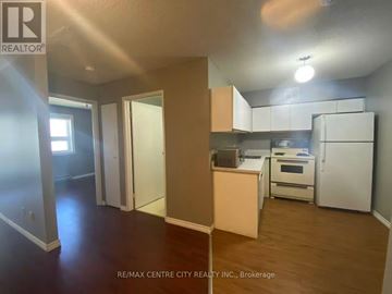 London North (North G) condo for rent - A kitchen area with white appliances and wooden floors.