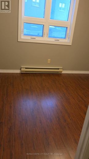 London North (North G) condo for rent - A room with a window and a wooden floor.