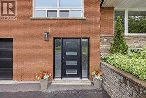 Hamilton duplex for rent - A red brick house with a black door and windows.