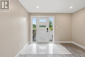 Hamilton duplex for rent - A room with a white door and a tiled floor.