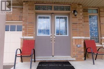 Innisfil apartment for rent - A house entrance with a glass door and two red chairs.