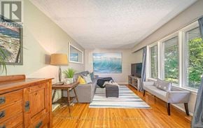 Oshawa (Mclaughlin) apartment for rent - A living room with a couch, chair, and a painting on the wall.