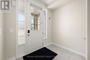 Kawartha Lakes (Lindsay) townhouse for rent - A hallway with a door and a black doormat.