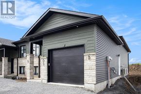 North Stormont duplex for rent - A grey house with a black garage door is for sale.