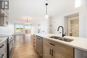 North Stormont duplex for rent - A modern kitchen with wooden floors and white countertops.