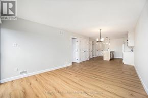 North Stormont duplex for rent - A large empty room with wooden floors and white walls.