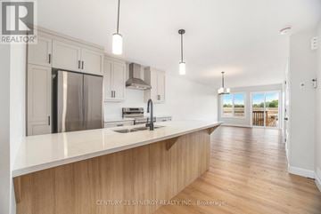 North Stormont multi-family for rent - A modern kitchen with wooden cabinets and a stainless steel refrigerator.