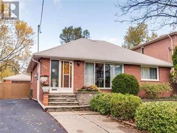 Toronto (Willowdale East) apartment for rent - A red brick house with a white door and a small front yard.