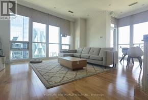 Toronto (Waterfront Communities) condo for rent - A living room with a couch, a rug, and a television.