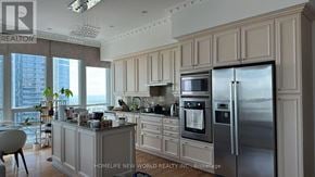 Toronto (Waterfront Communities) condo for rent - A kitchen with a refrigerator, microwave, and oven.