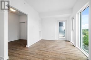 Toronto (West Hill) condo for rent - A room with wooden floors and white walls, with a doorway leading to another room.