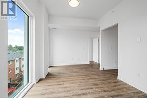 Toronto (West Hill) condo for rent - A white room with a wooden floor and a large window.