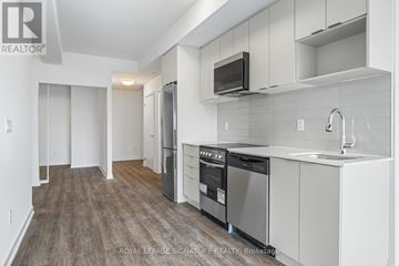 Toronto (West Hill) condo for rent - A kitchen with white cabinets and a wooden floor.