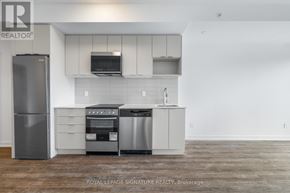 Toronto (West Hill) condo for rent - A kitchen with a refrigerator, oven, and microwave.