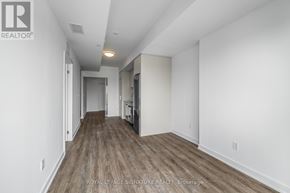Toronto (West Hill) condo for rent - A long hallway with wood floors and white walls.