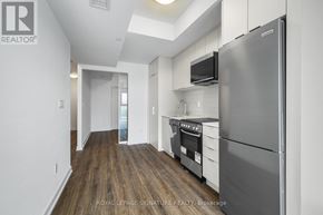 Toronto (West Hill) condo for rent - A kitchen with a refrigerator, oven, and microwave.