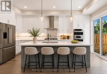 Toronto (Birchcliffe-Cliffside) apartment for rent - A modern kitchen with white cabinets and a large island.
