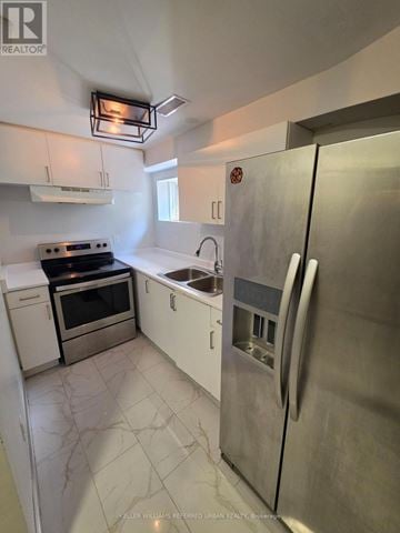 Mississauga (Meadowvale Village) apartment for rent - A kitchen with a stainless steel refrigerator, oven, and sink.