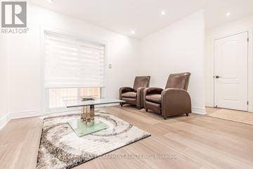 Vaughan (West Woodbridge) townhouse for rent - A living room with a glass coffee table and two brown chairs.