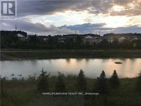 Newmarket (Woodland Hill) apartment for rent - A landscape image with a lake, houses and trees in the background.