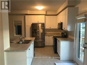 Newmarket (Woodland Hill) apartment for rent - A kitchen with white cabinets and stainless steel appliances.