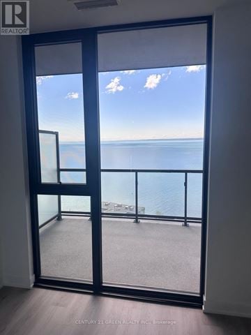 Burlington (Brant) condo for rent - A view of the sea through a glass door.