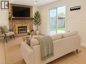 Dundas apartment for rent - A living room with a couch, a fireplace, and a television.