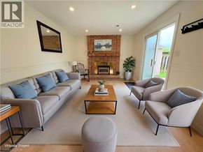 Dundas apartment for rent - A living room with a grey couch, a coffee table, and a fireplace.