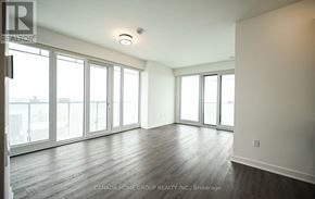 Mississauga (City Centre) condo for rent - A spacious room with wood flooring and large windows.
