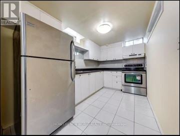 Richmond Hill (Devonsleigh) apartment for rent - A kitchen with white cabinets and a stainless steel refrigerator.