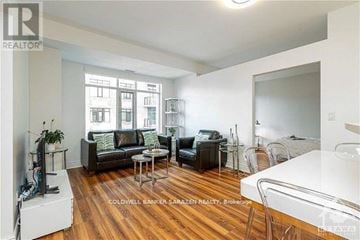 Ottawa condo for rent - A living room with a white couch and a black leather couch.