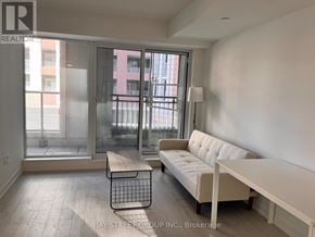 Toronto (Humber Heights) condo for rent - A living room with a white couch and a coffee table.
