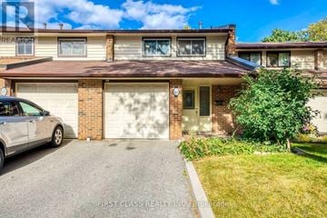 Mississauga (Erin Mills) apartment for rent - A house with a garage and a car parked in front.
